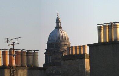 A view of Edinburgh University's Old College through the chimney pots of the Old Town from the roof terrace at 8 Jeffrey Street University Old College